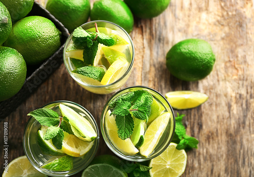 Fresh mojito drinks with lime  lemon and mint on wooden table