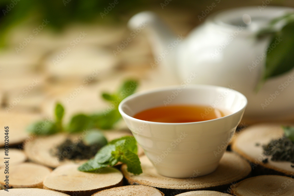 Cup of tea and teapot on table Cup of tea and teapot on table