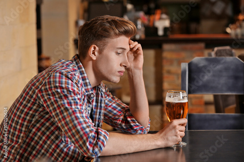 Young man sitting alone in ...