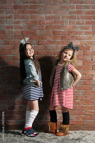 Two stylish little girls on...
