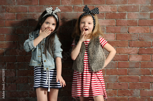Two stylish little girls on...