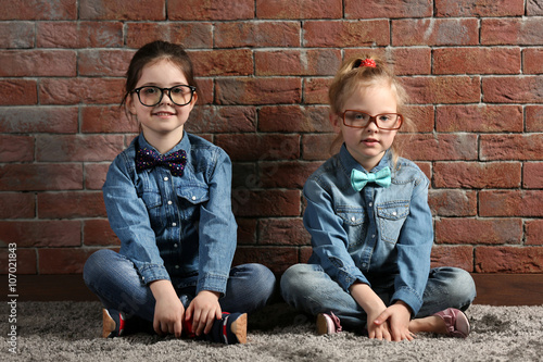 Two stylish little girls on...