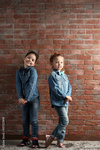 Two stylish little girls on...