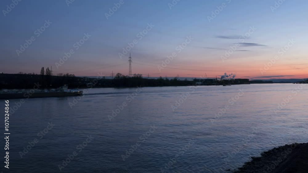 Time lapse shot of River Rhine and cargo ships at dusk Time lapse shot of River Rhine and cargo ships at dusk