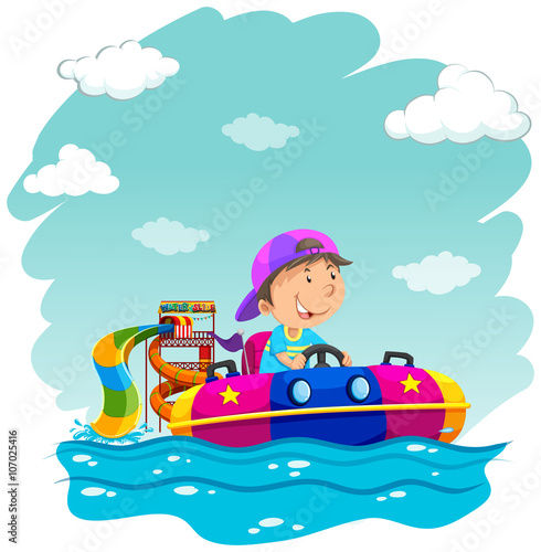 Boy riding on rubber boat at park