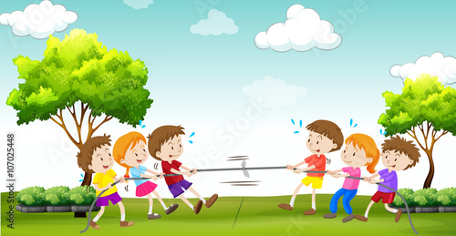 Children play tug of war in the park