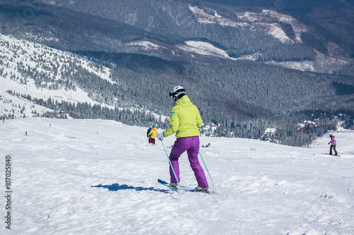 beautiful girl in a ski suit goes skiing