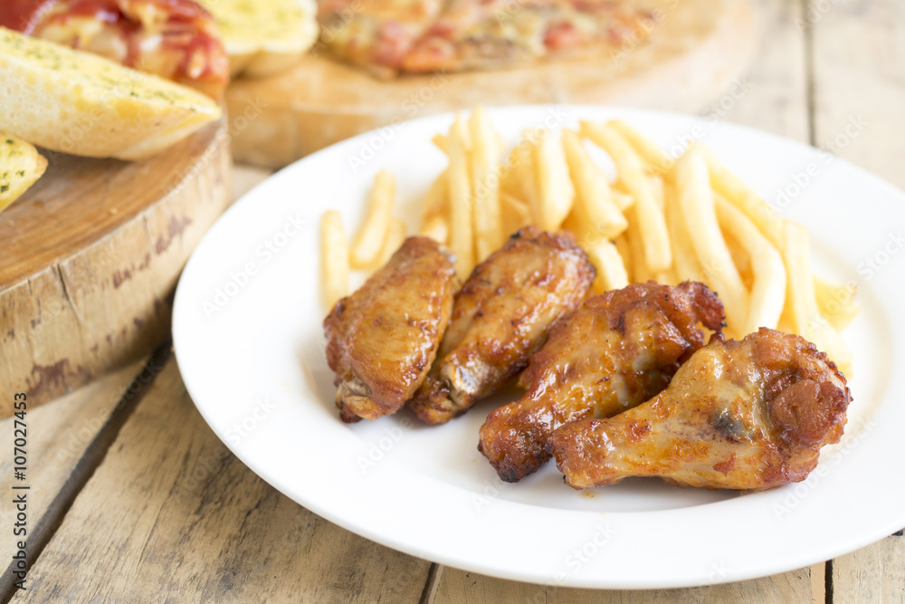 Fast food, crispy chicken wings,bread,french fries and pizza on