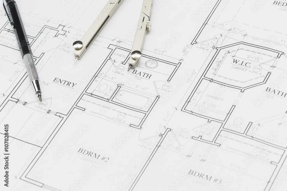 Engineer Pencil and Compass Resting on House Plans Engineer Pencil and Compass Resting on House Plans