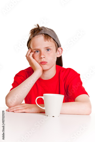Depressed boy with white mug