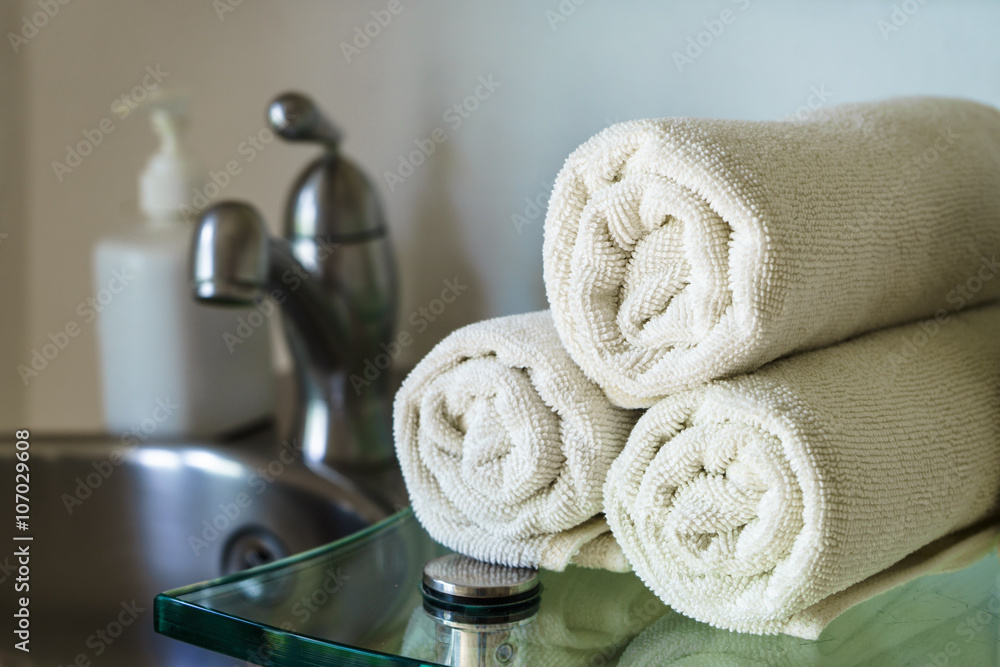 White towels heap on shelf in bathroom White towels heap on shelf in bathroom