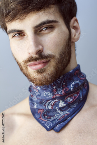 Valokuva Close up of handsome man with long beard and blue scarf around his neck
