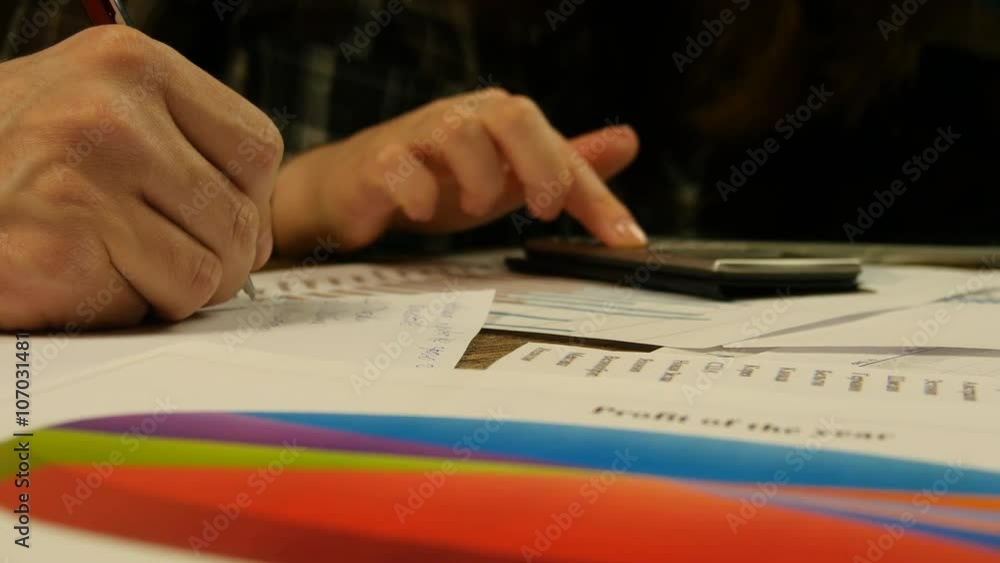 Hands of businessman and businesswoman.New charts and graphs appear on the table Hands of businessman and businesswoman.New charts and graphs appear on the table