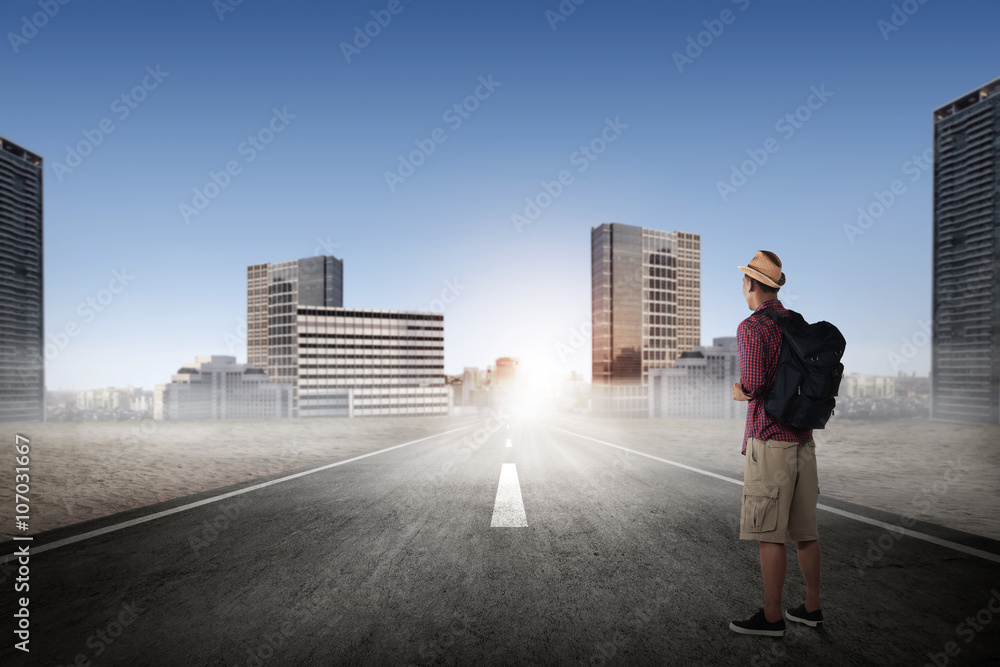 Asian man hiking alone on the street