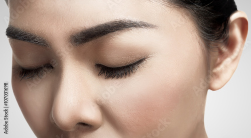 Asian woman's eyes closed