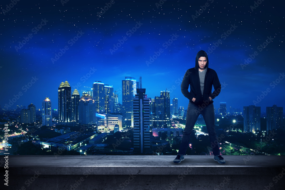 Bad guy standing on the building rooftop Bad guy standing on the building rooftop