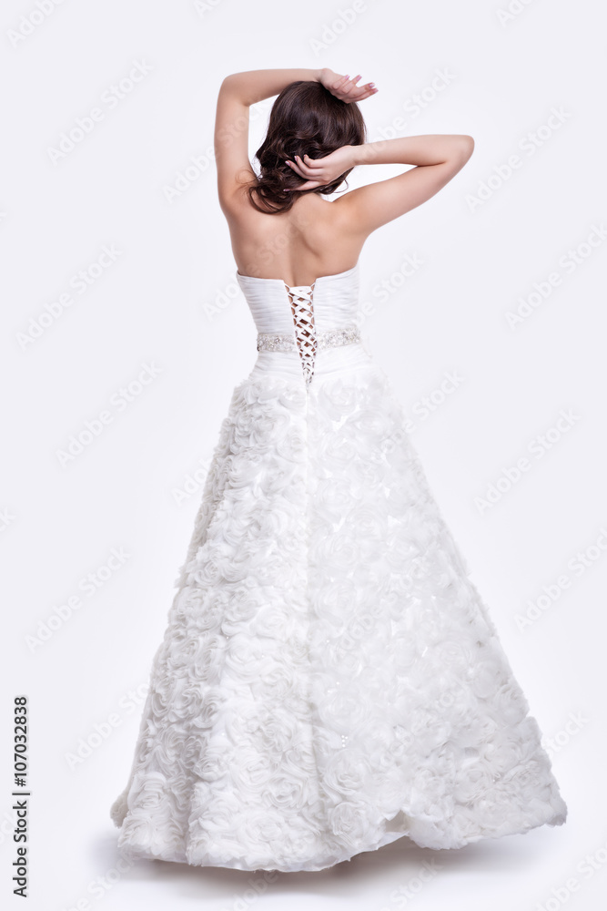 Fototapeta premium Portrait of beautiful young brunette woman bride in white Weddin