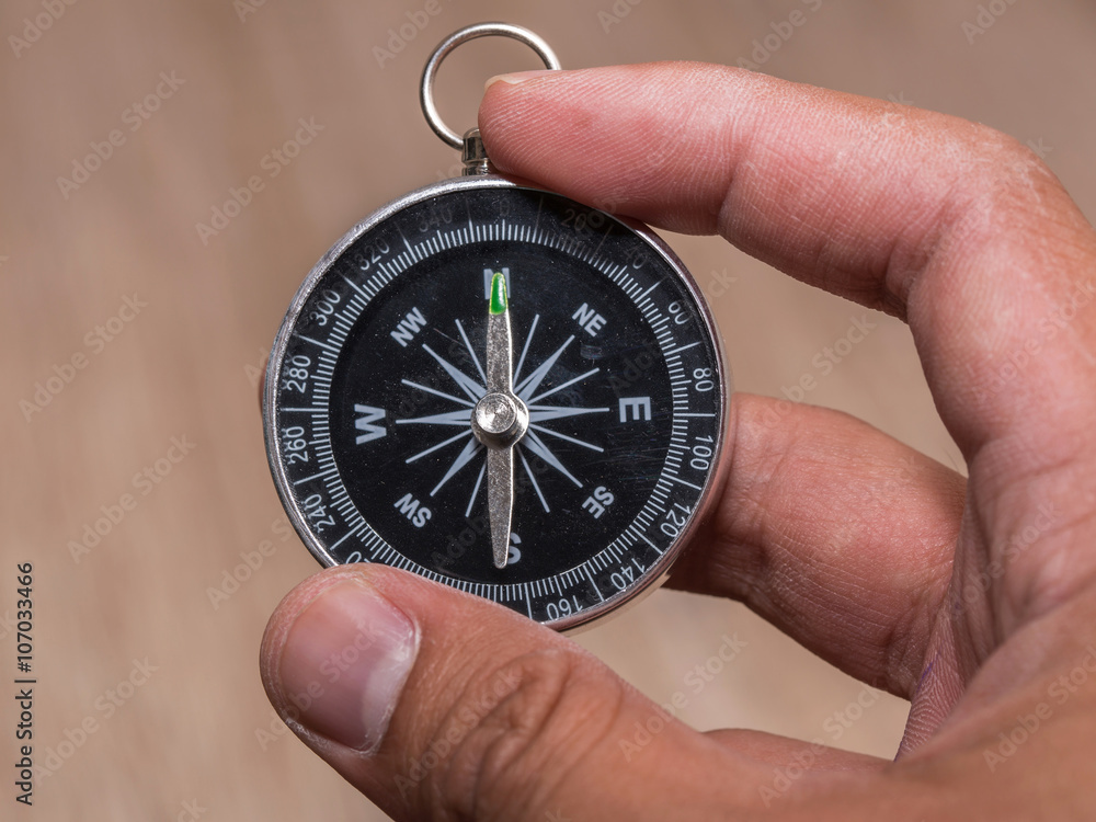 Close up of compass and point to North and hold by hand. Close up of compass and point to North and hold by hand.