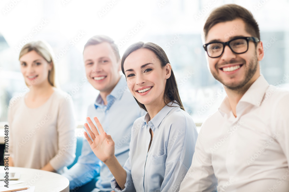 Pleasant colleagues sitting at the table Pleasant colleagues sitting at the table