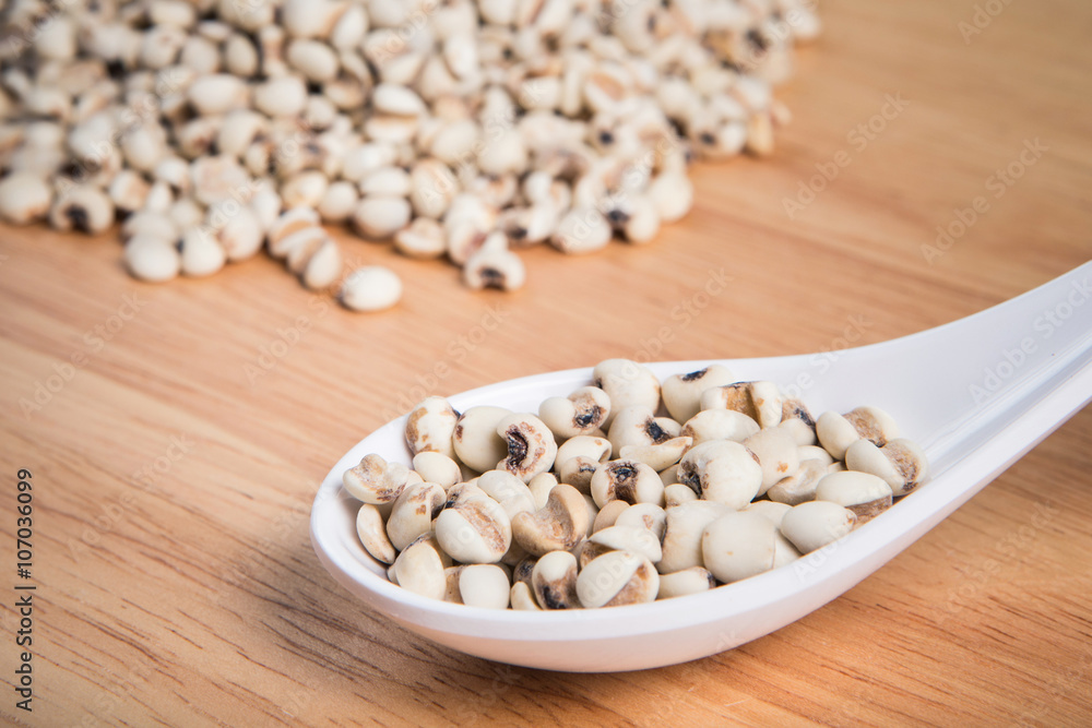 spoon of millet in front of a blurry pile of millet.Selective fo spoon of millet in front of a blurry pile of millet.Selective fo