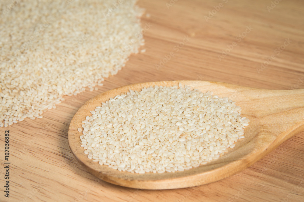 scoop of sesame in front of a blurry pile of sesame.Selective scoop of sesame in front of a blurry pile of sesame.Selective