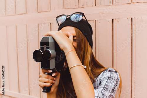 Attractive young lady,stylish hipster woman walking on street,wearing cute trendy outfit,make self portrait,smiling enjoy weekends,travel with backpack,hat,rest,lounge