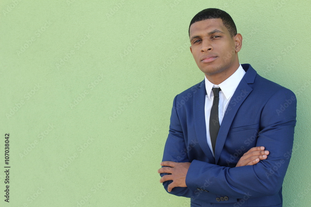 Young successful businessman posing in elegant suit against green background with copy space Young successful businessman posing in elegant suit against green background with copy space