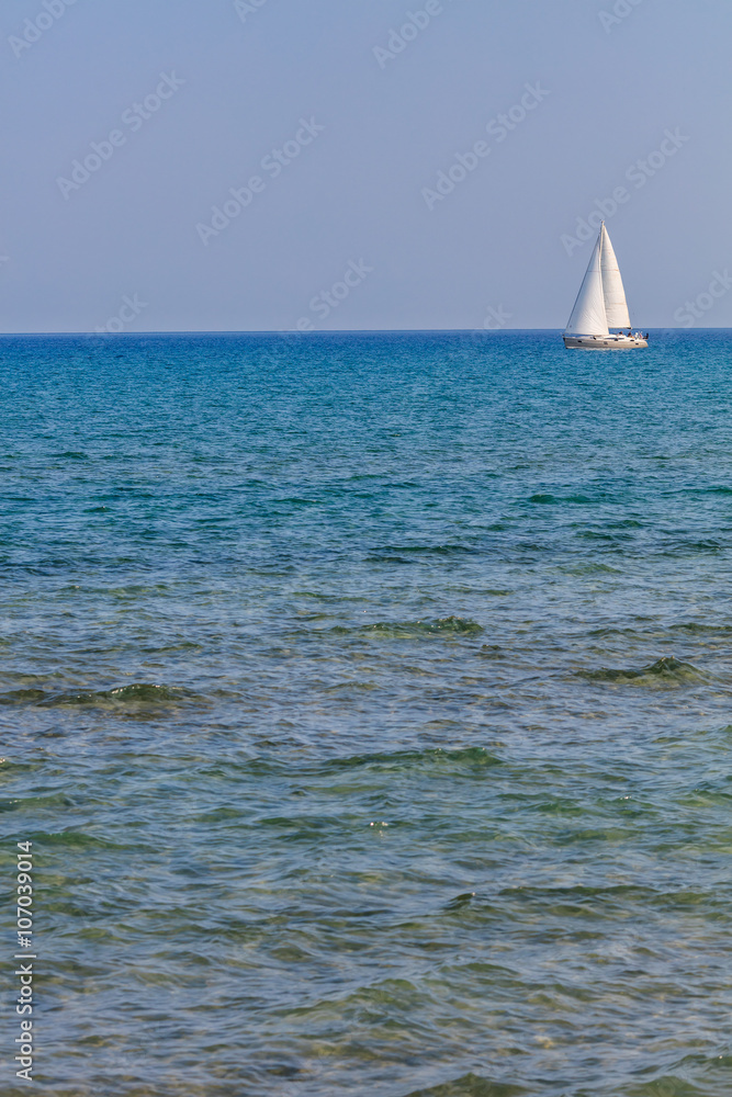 White sail in Mediterranean sea, Larnaca, Cyprus