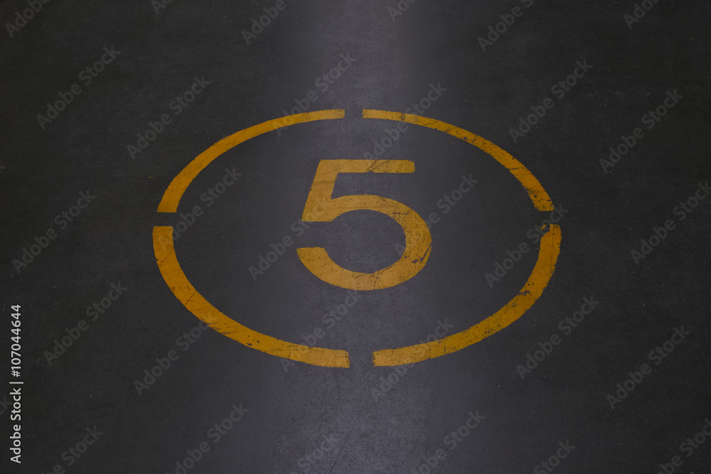 Fototapeta premium Number five is written with yellow paint