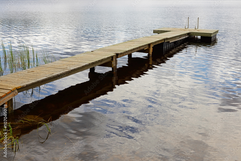 Fototapeta premium Footbridge among clouds. Reflection