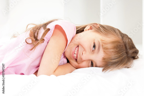 Adorable little girl awaked up in her bed