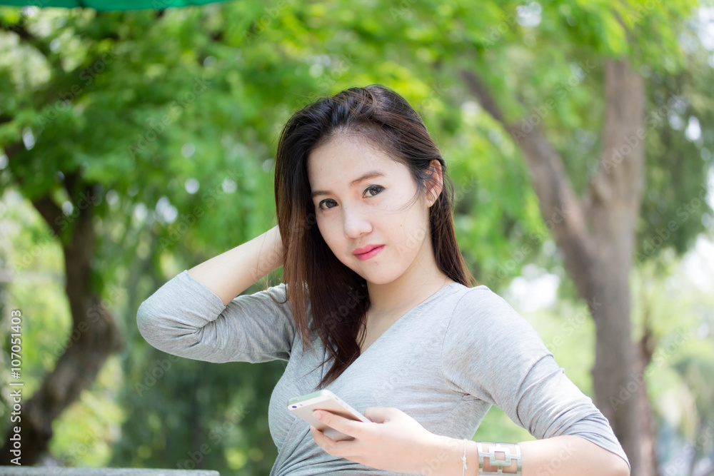 Portrait of thai adult beautiful girl using her smart phone. Portrait of thai adult beautiful girl using her smart phone.