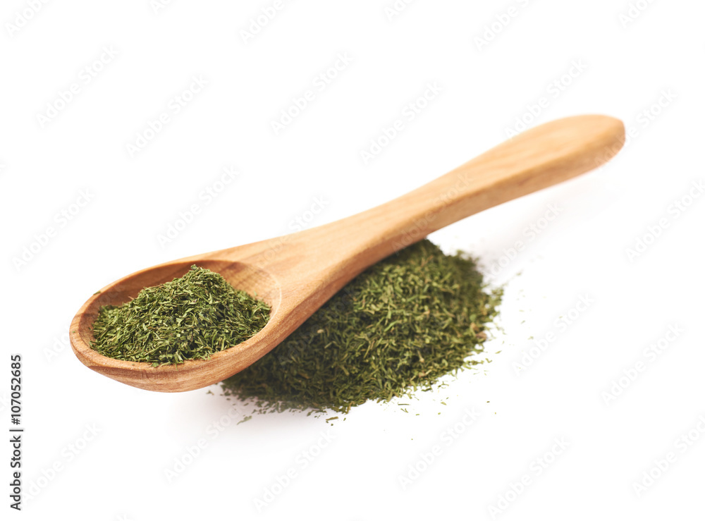 Spoon over pile of dried dill Spoon over pile of dried dill