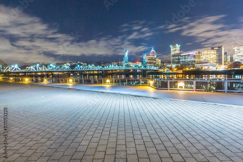 empty brick floor with cityscape and skyline of portland at nigh