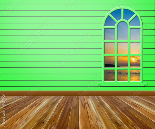 Empty room with wood floors and windows.