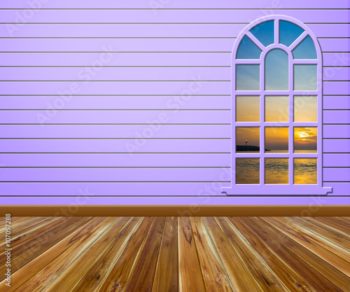 Empty room with wood floors and windows.