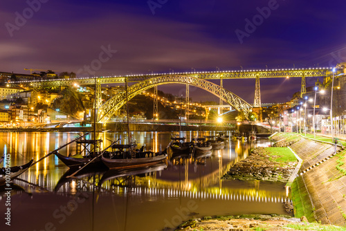 Dom Luis I bridge over Douro river illuminated at night, Porto, Portugal.