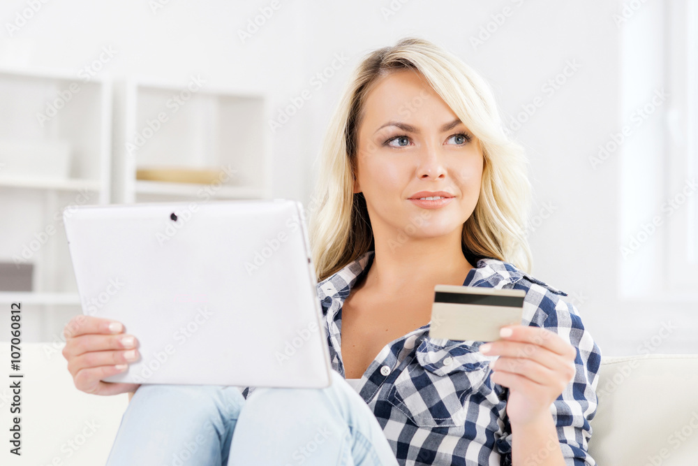 Attractive woman with a credit card and a tablet Attractive woman with a credit card and a tablet