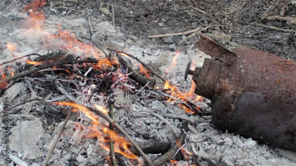 burning rusty extinguisher/burns rusty old fire extinguisher in nature burning rusty extinguisher/burns rusty old fire extinguisher in nature