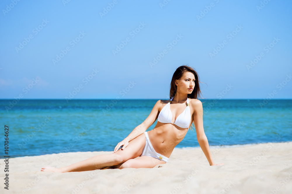 Beautiful young girl relaxing on a summer beach Beautiful young girl relaxing on a summer beach