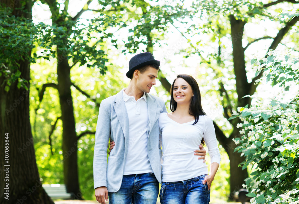 Young beautiful couple posing in the park
