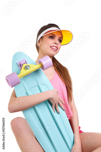 sexy young seductive woman posing with longboard desk on white background