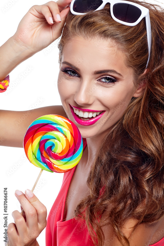 Portrait of a beautiful fit girl with big lollipop. Portrait of a beautiful fit girl with big lollipop.