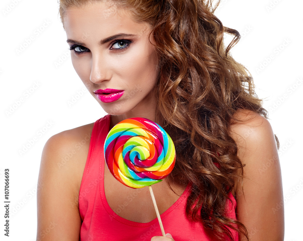 Portrait of a beautiful fit girl with big lollipop.