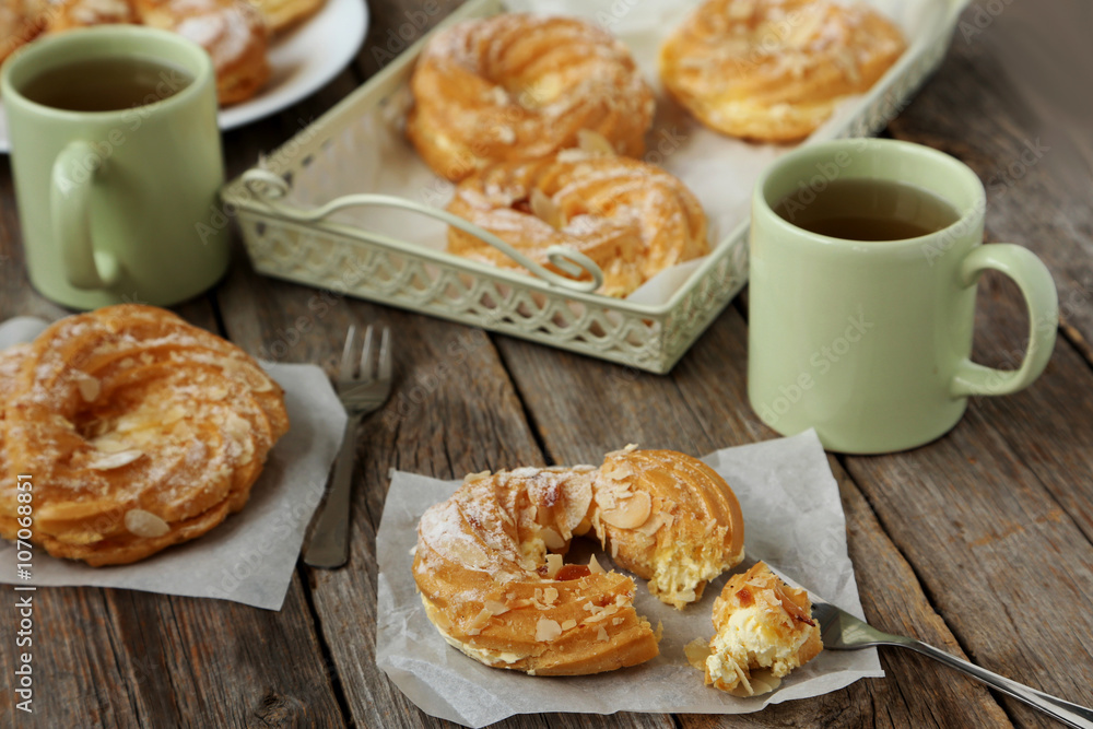 Sweet eclairs on a grey wooden table Sweet eclairs on a grey wooden table