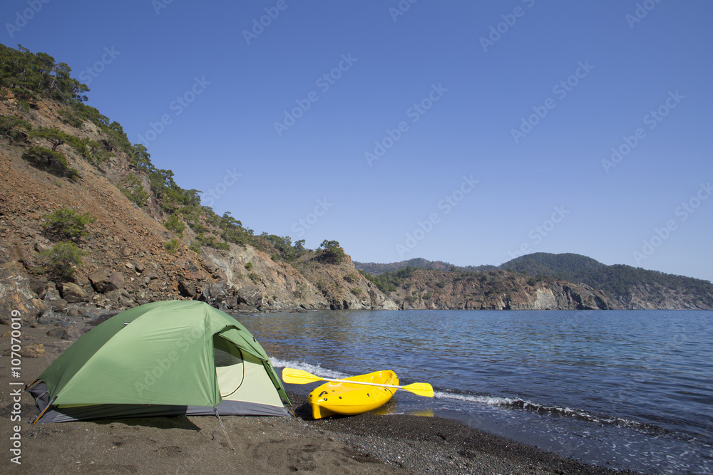 Camping on the beach.Kayak on the beach on a sunny day. Camping on the beach.Kayak on the beach on a sunny day.