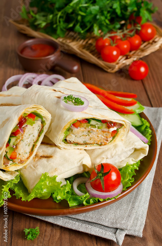 Shawarma with meat and vegetables wrapped in pita bread