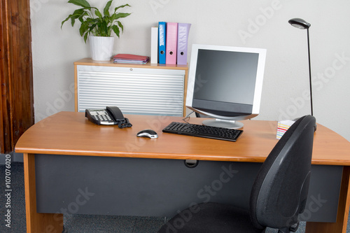 Modern office monitor on the desk with nobody © OceanProd