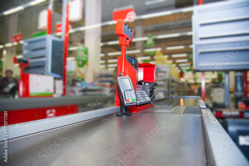 Cash desk with payment terminal in supermarket photo
