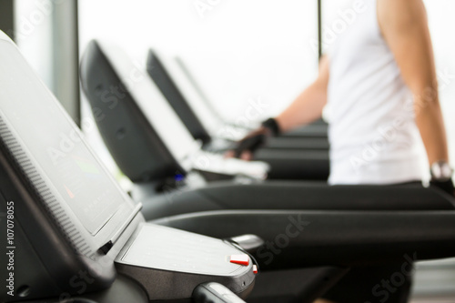 young handsome asian man works out in modern gym